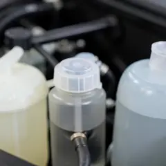 Engine bay fluid reservoirs